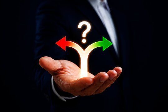 Business person holding a hand out with a glowing question mark above ay shaped path with a red arrow pointing left and a green arrow right