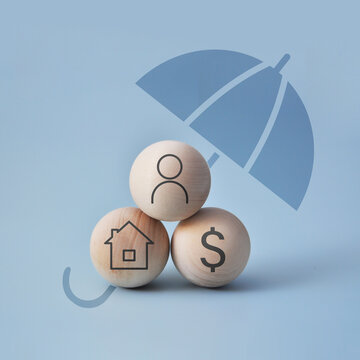 Umbrella protecting family home and money symbols. Insurance concept