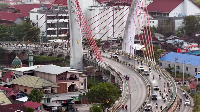 A view of Banjarmasin city and the Alalak River Bridge (or Basit Handil Bakti Bridge) in the sunset