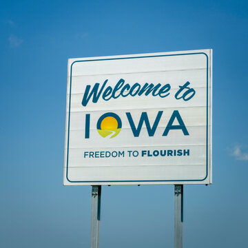 Welcome to Iowa - roadside sign against blue sky at state border with Missouri,  travel concept