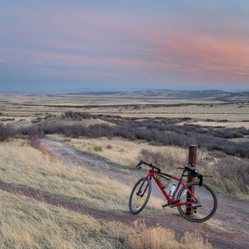 dusk over northern Colorado foothills and prairie with a gravel bike at trail crossing - Soapstone Prairie Natural Area in early spring scenery