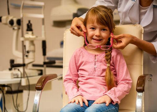 Child Trying Pink Eyeglasses.