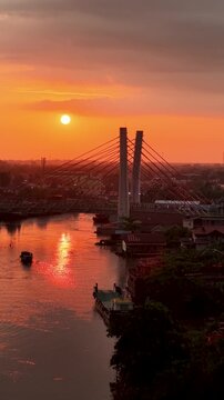 A view of Banjarmasin city and the Alalak River Bridge (or Basit Handil Bakti Bridge) in the sunset