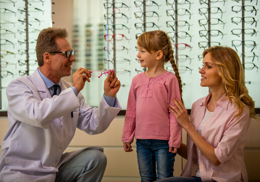 Child Choosing Pink Eyeglasses.