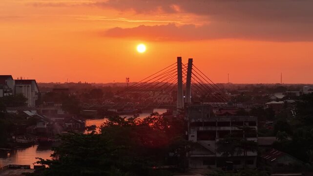 A view of Banjarmasin city and the Alalak River Bridge (or Basit Handil Bakti Bridge) in the sunset