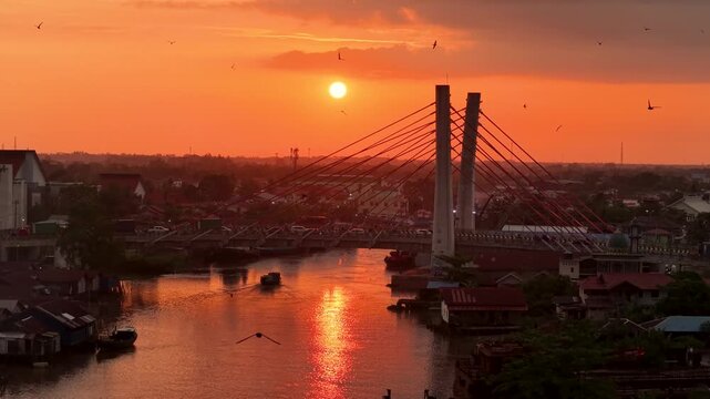A view of Banjarmasin city and the Alalak River Bridge (or Basit Handil Bakti Bridge) in the sunset