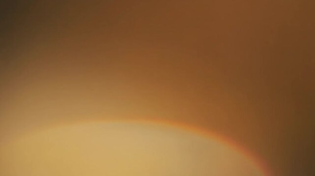 Warm honey-gold gradient light shifts and blends gradually across deep black, creating soft ambient glow, calming cinematic atmosphere, smooth color transitions, and elegant abstract motion.