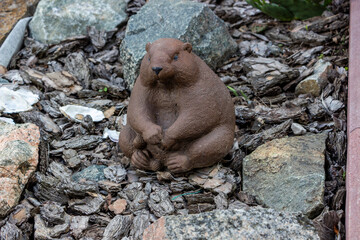 garden statue of  brown marmot among stones in garden, decorative, garden and park, beaver figurine © Studio  GULL