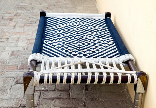 Traditional Indian Woven Bed Charpai on Paved Ground