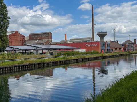 Beerse, Belgium, July 19, 2026 - Campine industrial facility along the canal in Beerse, Belgi&euml; with wind turbine and water tower