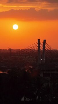 A view of Banjarmasin city and the Alalak River Bridge (or Basit Handil Bakti Bridge) in the sunset