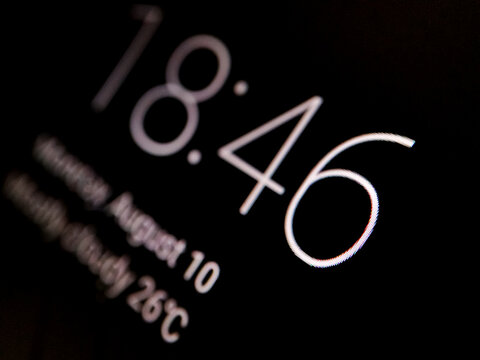 Close up of digital clock interface on smartphone lock screen