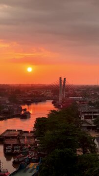 A view of Banjarmasin city and the Alalak River Bridge (or Basit Handil Bakti Bridge) in the sunset