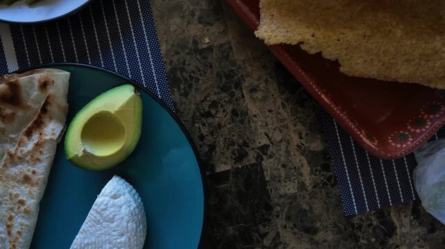 Ingredients for traditional mexican taco placero with avocado, cheese, and pork rind