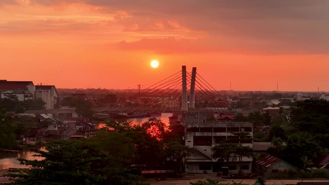 A view of Banjarmasin city and the Alalak River Bridge (or Basit Handil Bakti Bridge) in the sunset