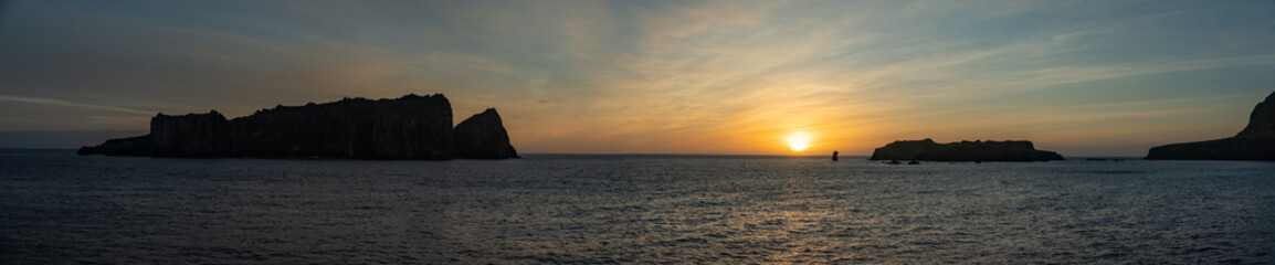 Fototapeta premium Panorama of Nightingale Island in silhouette at sunrise, in the South Atlantic Ocean