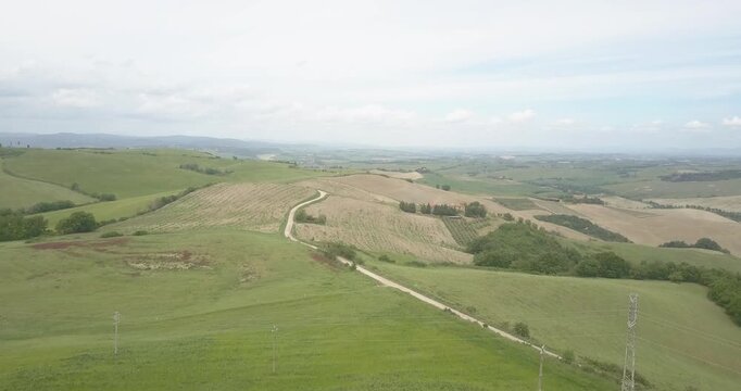 Val d'Orcia, Tuscany, Italy, aerial drone view, winding road with cypresses