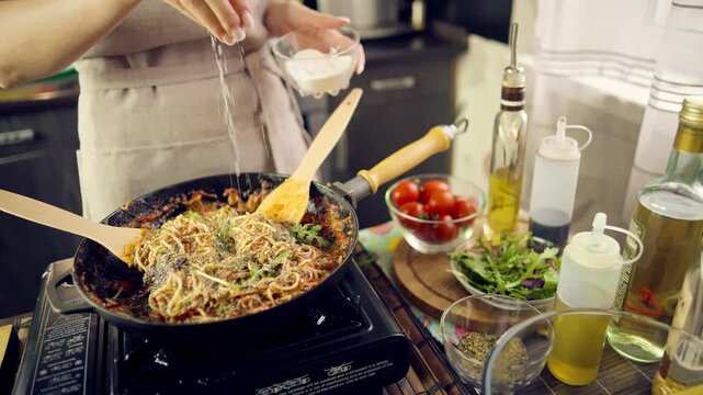 Chef Salting Pasta. Cooking Spaghetti With Tomato Sauce In Skillet Pan