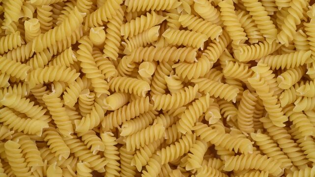 Raw pasta fusilli close-up, top view