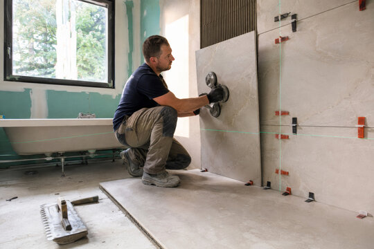 Trabajo de instalaci&oacute;n de baldosas en un ba&ntilde;o en remodelaci&oacute;n