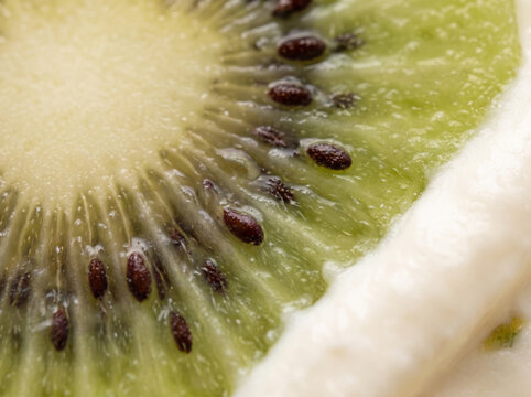Extreme macro close up of a fresh kiwi slice with black seeds