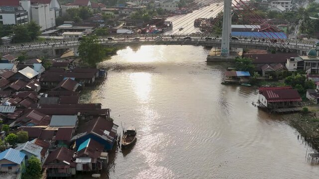 A view of Banjarmasin city and the Alalak River Bridge (or Basit Handil Bakti Bridge) in the sunset