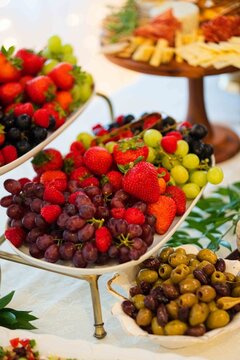 elegant fruit display on banquet table close-up with strawberries, grapes, raspberries, and olivesp.
