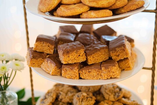 warmly stacked chocolate-covered cookies in a porcelain vase on a metal stand in a cozy kitchen orl.