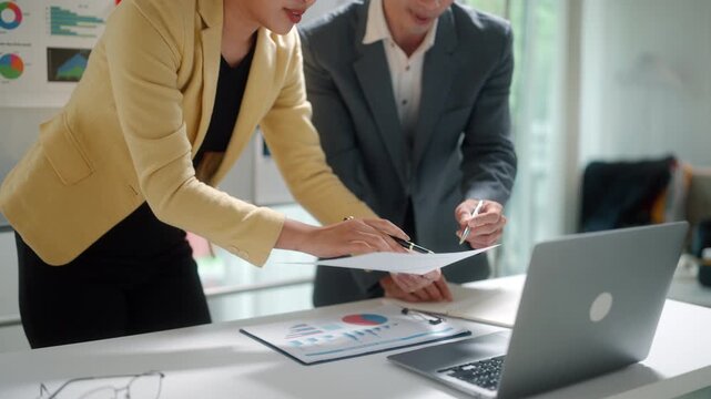 Business Team Discussing Data Analysis on Laptop
