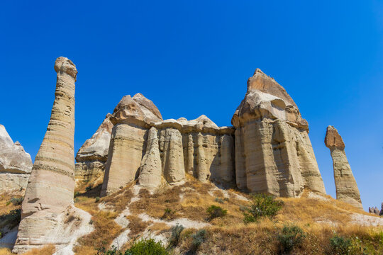 Fairy chimneys in Love Valley, Cappadocia. Hiking adventure and sustainable travel concept.
