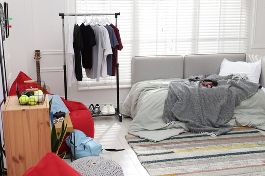 Teenager's room with stylish furniture and clothes. Interior design