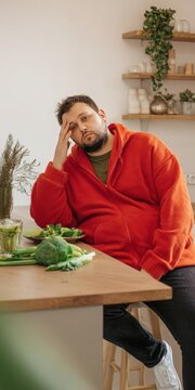Frustrated man struggling with diet and healthy food