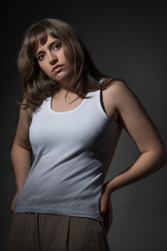 Portrait of a young woman with bangs looking at camera