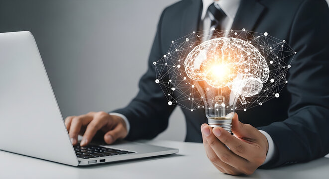 Businessman working on a laptop holding a glowing light bulb with a digital brain network representing creative ideas and innovative business solutions