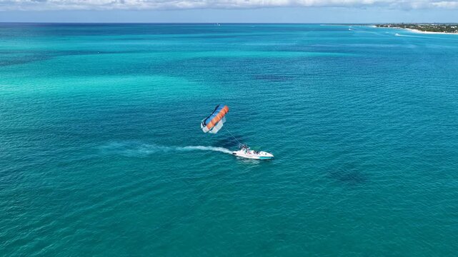Parasailing At Providenciales In Turks And Caicos. Idyllic Beach. Nature Landscape. Aquatic Sport. Parasailing In Turks And Caicos. Aquatic Sport Landscape.