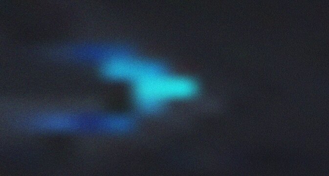 Mysterious deep blue light emerging from the darkness creating an ethereal and captivating fluid motion