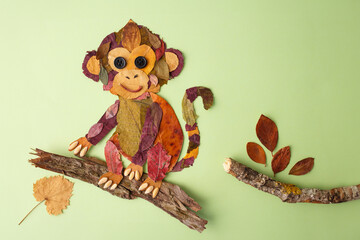 Handmade autumn leaf monkey figure on branch for toy store, child development center, party decoration, family blog, homeschooling, © Elena