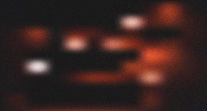 Warm glowing orange and red light patches creating a fiery abstract visual with subtle grain texture