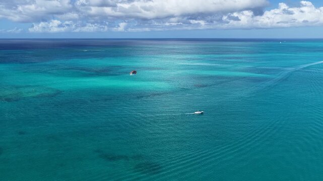 Parasailing At Providenciales In Turks And Caicos. Idyllic Beach. Nature Landscape. Aquatic Sport. Parasailing In Turks And Caicos. Aquatic Sport Landscape.