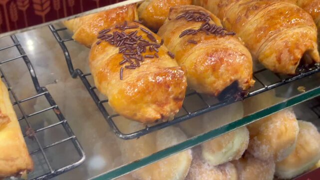 Assorted bakery pastries donuts waffles and pisang bolen display