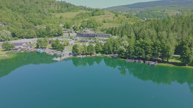 Aerial Drone View of Pliva Lake in Bosnia and Herzegovina with Emerald Green Water and Mountain Reflections