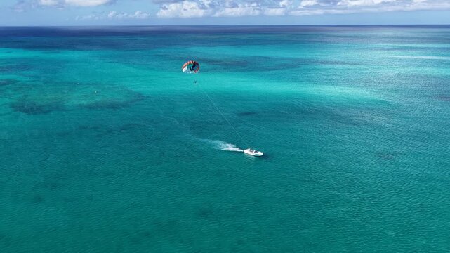 Parasailing At Providenciales In Turks And Caicos. Idyllic Beach. Nature Landscape. Aquatic Sport. Parasailing In Turks And Caicos. Aquatic Sport Landscape.
