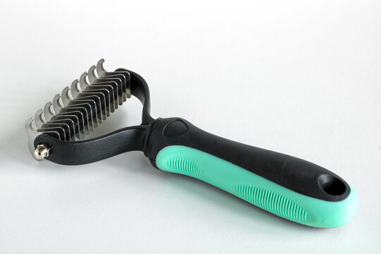 Pet Grooming Tool for Removing Tangled Fur and Mats from Cat Coat Isolated on White Background