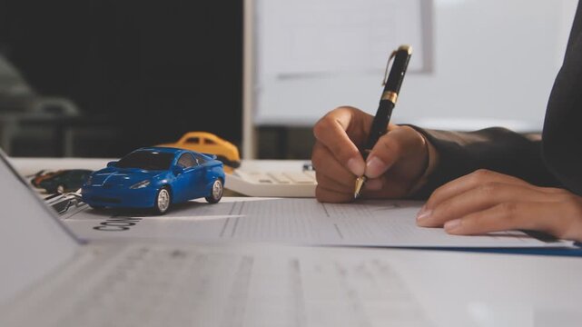 Car sale or rental concept, Closeup Dealership manager signing car insurance document or lease paper contract. Customer with car dealer agent making deal, sign on agreement document contract in office