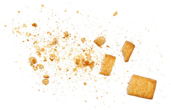 Wholemeal cookies pieces and crumbs, isolated on white background and texture, explosion effect, top view, design element