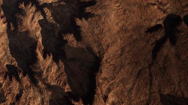 The scene shows a rocky surface with deep shadows created by uneven terrain. The natural formations reveal the rough texture and contours of the ground under bright light.