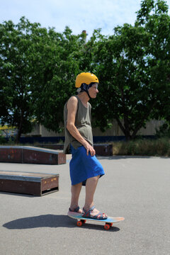 Elderly woman riding her skateboard in skate park