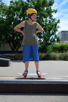 Elderly woman riding a skateboard in skate park