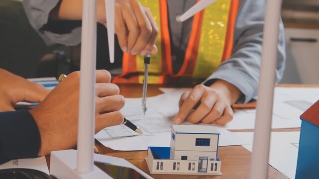 Meeting between the architect and the works manager at the office to discuss the progress of the site and check compliance with the plans