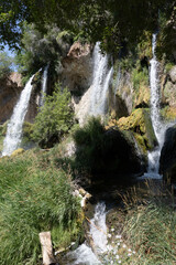 Scenic Waterfall Cascading Through Lush Greenery © Mikhail